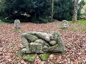 Sculpture in a French medieval village reclining woman autumn leaves